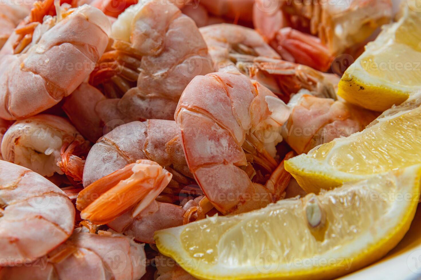 Boiled king prawns in a deep bowl with lemon photo