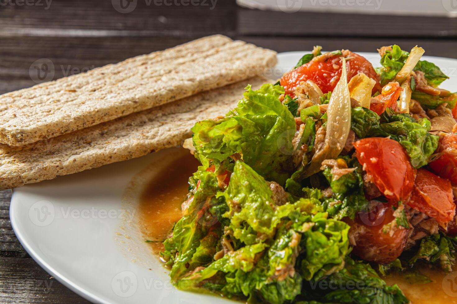 vegetable salad with tuna dressed with natural honey with rye bread closeup view photo