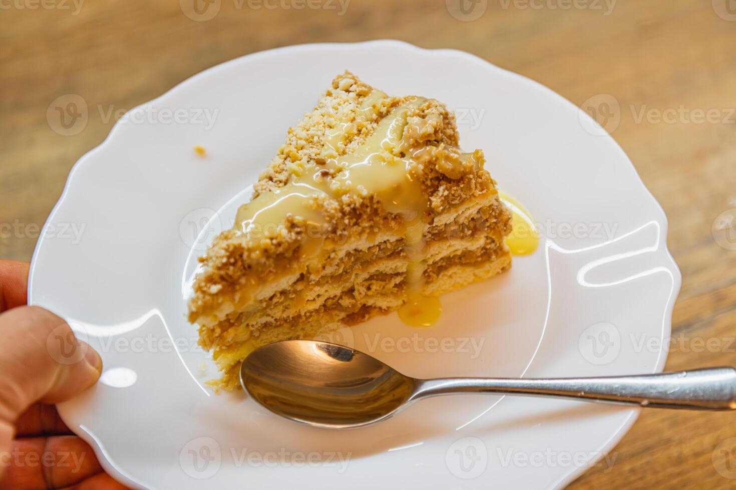 fresh homemade apple cake with condensed milk on a plate in hand photo