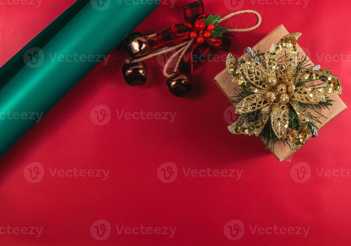 Christmas composition with a gift box and decorations with bells and a bow photo