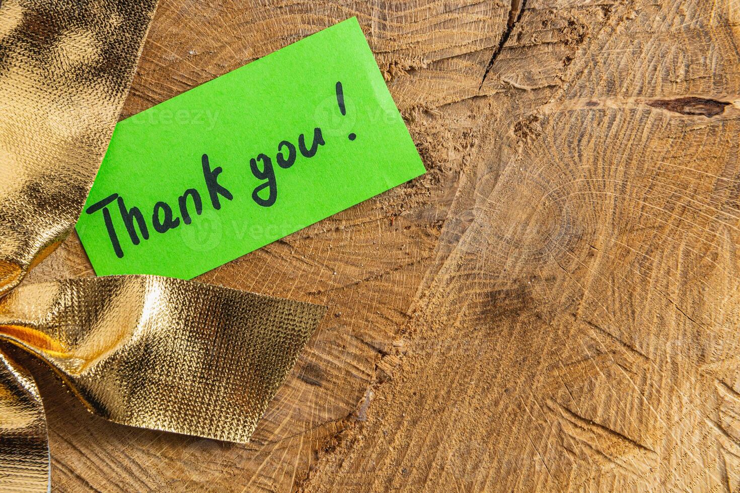 A word of thanks to a small green leaf on a piece of wood next to the bow photo