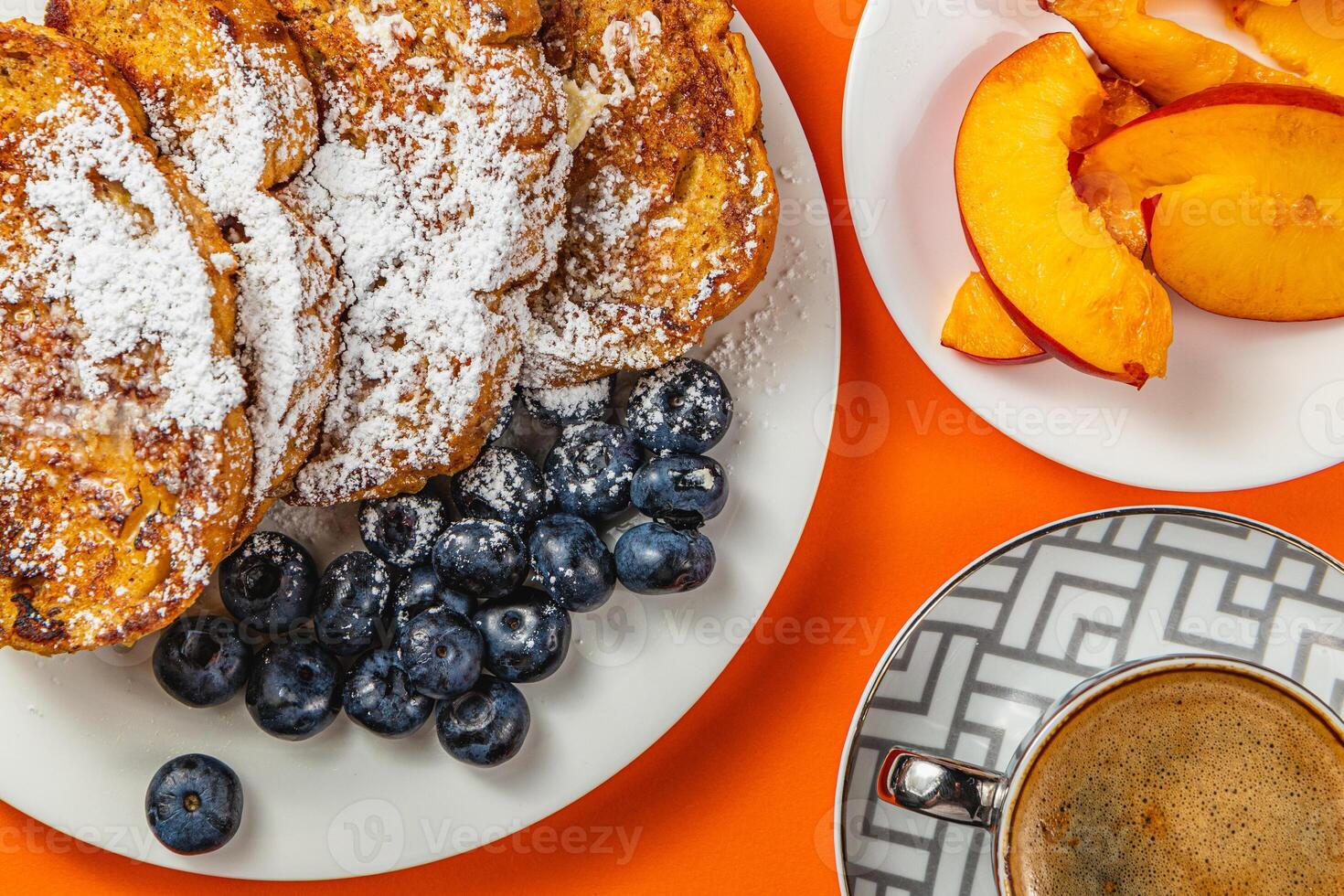 French toast on a plate with blueberries, orange juice, nectarine for breakfast photo