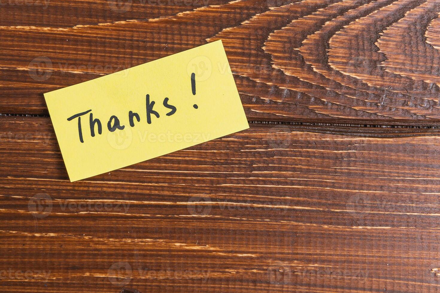 yellow sticky note with the word thanks written on it. photo