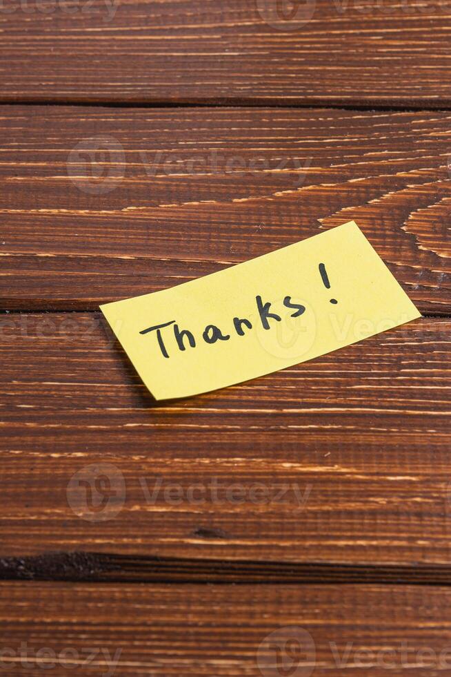 yellow sticky note with the word thanks written on it. photo