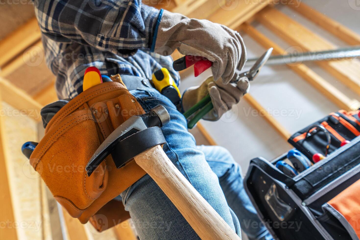 A Carpenter Prepares Tools While Working on a Construction Project in a Home Under Renovation photo