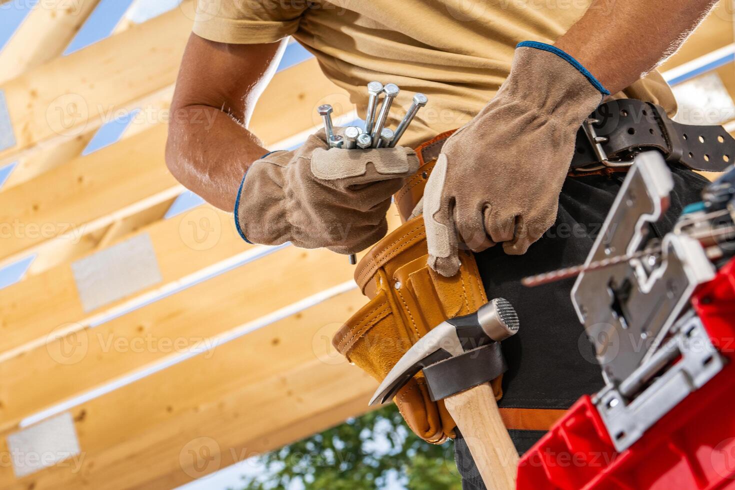 Skilled Carpenter Organizing Tools in a Workshop While Preparing for a Project on a Sunny Day photo