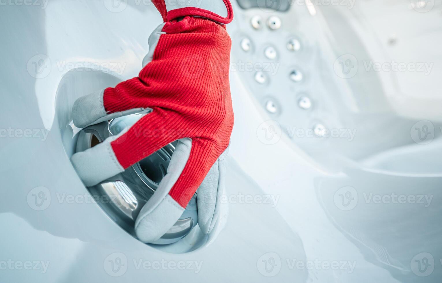 Hand Adjusting a Control Knob in a Modern Hot Tub at a Spa During the Afternoon photo