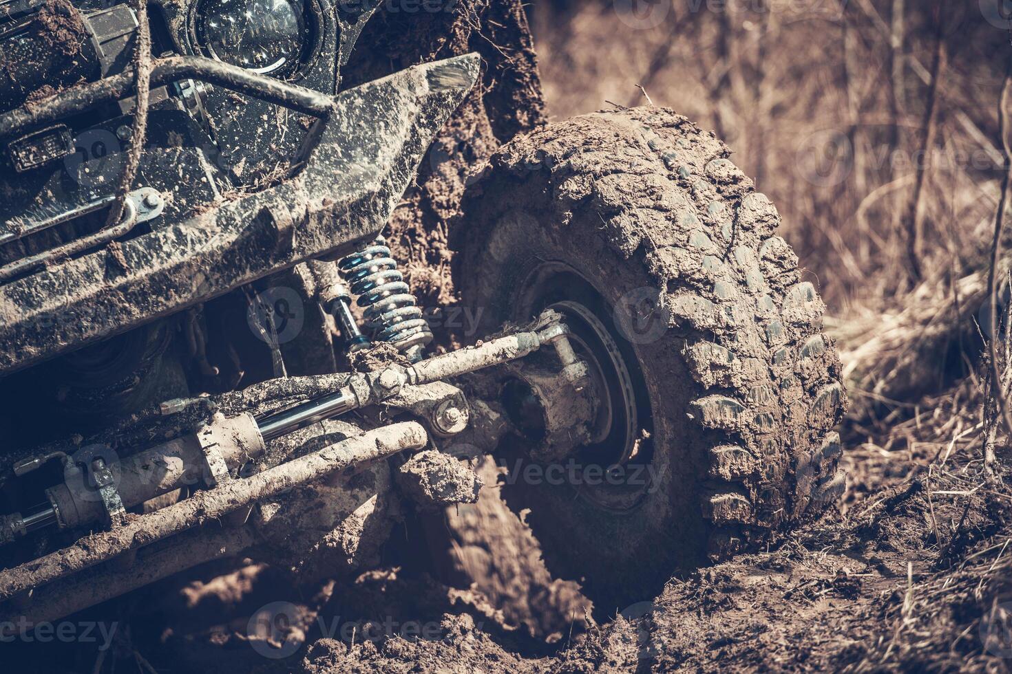 Off-road Vehicle Tackling Muddy Terrain in the Wilderness During Daytime Adventure photo