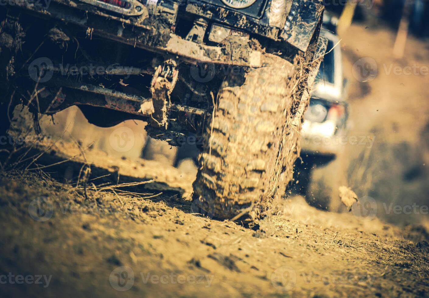 Off-road Vehicles Navigate a Muddy Terrain During an Adventurous Outdoor Event in the Countryside photo