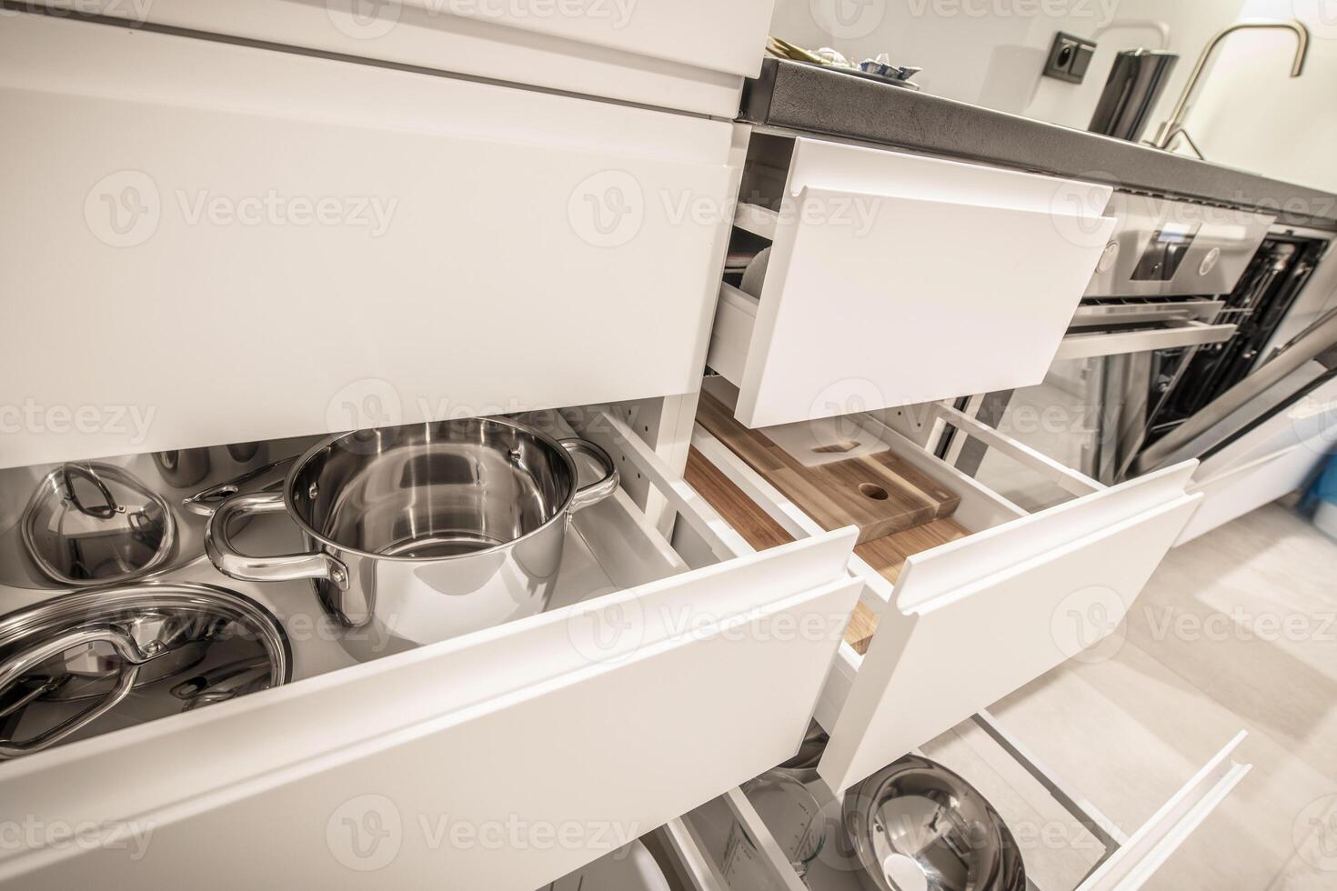 Modern Kitchen With Open Drawers Showcasing Organized Cooking Pots and Utensils in a Sleek Design photo