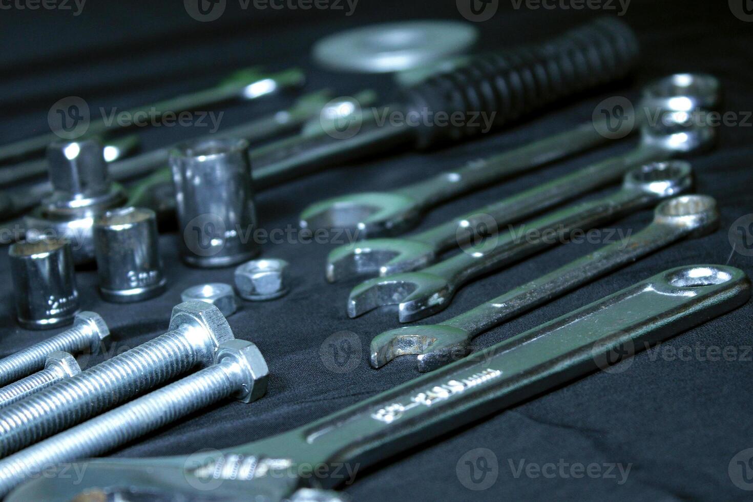 Wrenches, Bolts And Socket Spanners Isolated On Black Inclain Shot photo