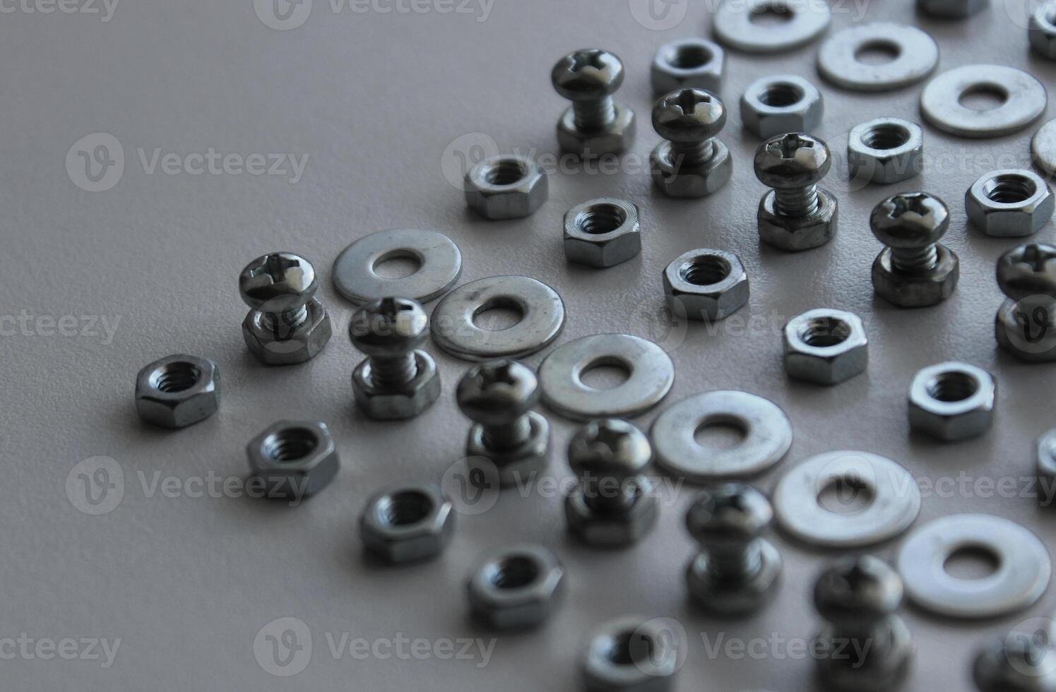 Metal Steel Fastener And Fixing Parts In Even Lines On Plastic Surface Detailed Stock Photo. Ironware Goods Royalty Free Background photo