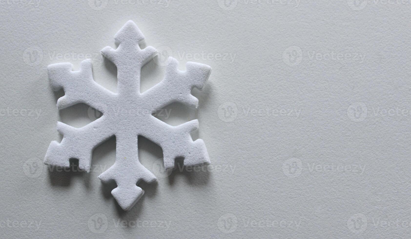 Snowflake Figurine On Clean White Surface Similar To Snow. Snowflake On White With Copy Space Stock Photo