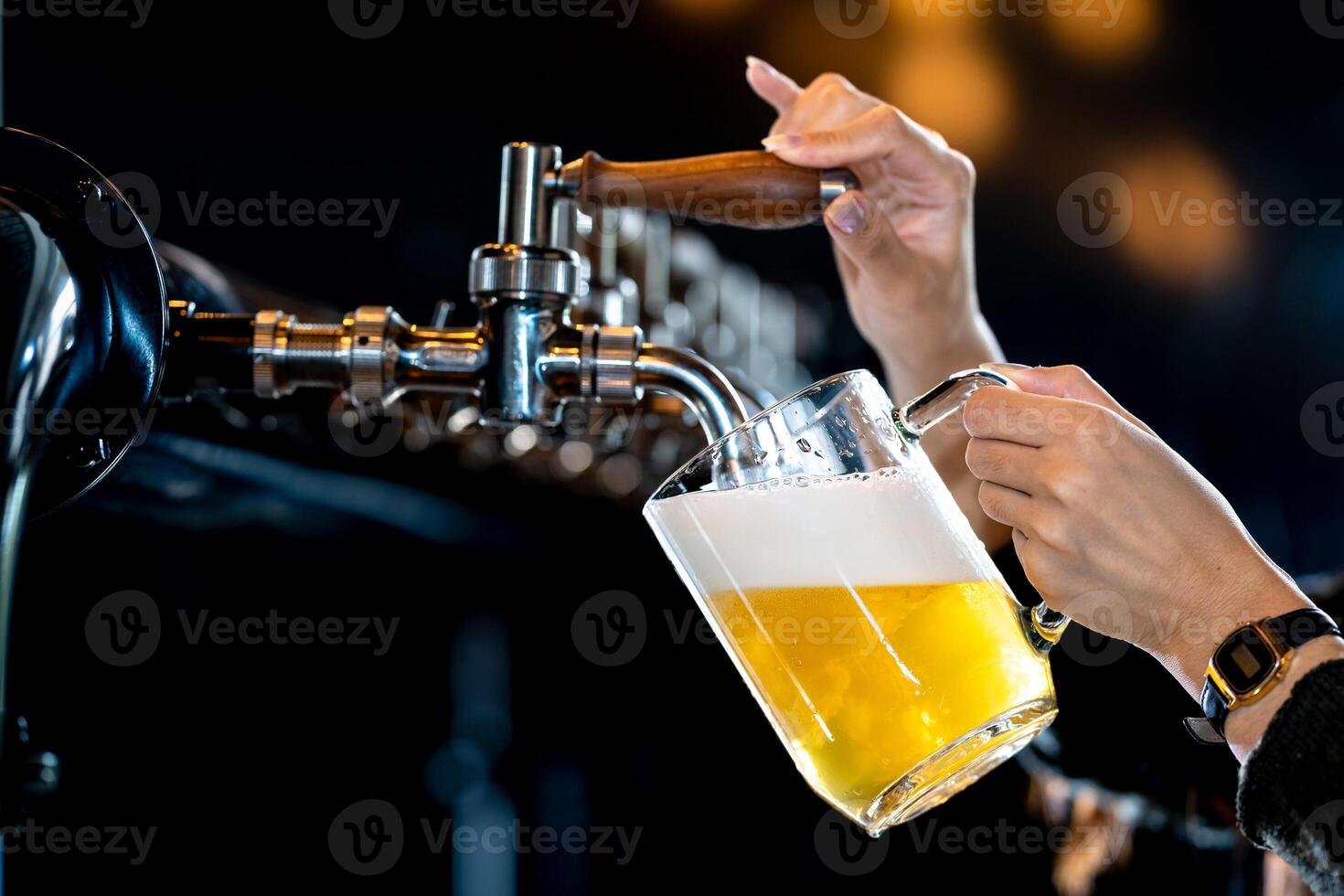 Bartender pouring beer from tap in pub photo