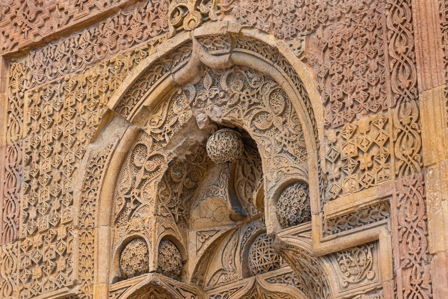 Gate of Great Mosque of Divrigi aka Divrigi Ulucami with carved stone decoration photo