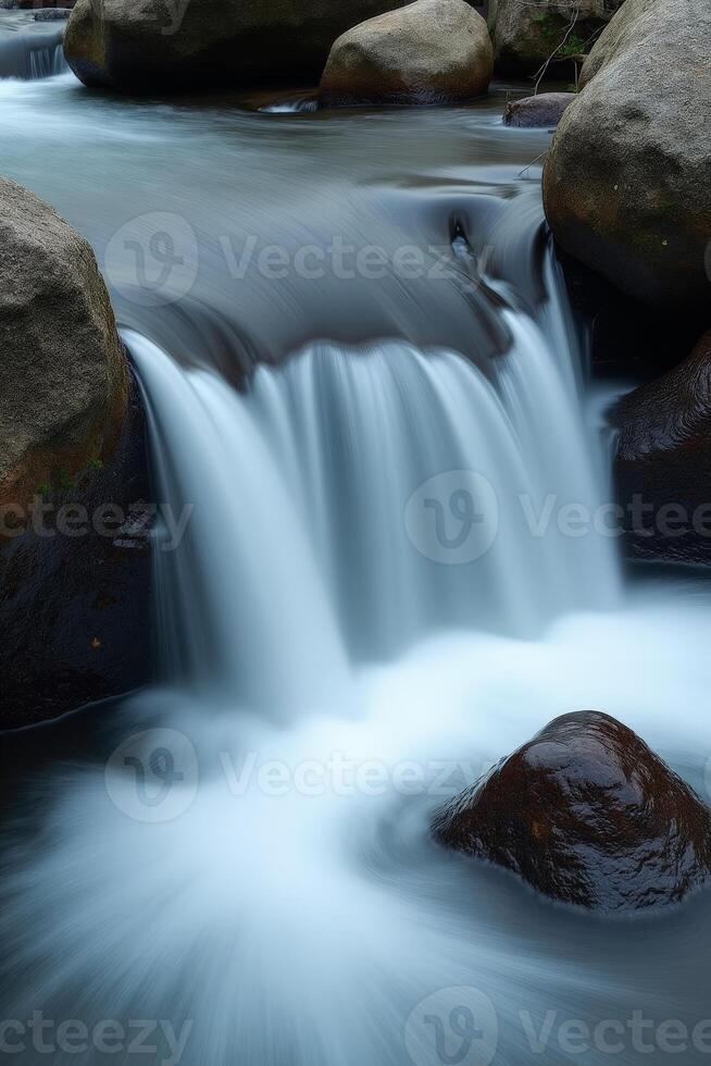 A waterfall flowing over rocks in a river photo