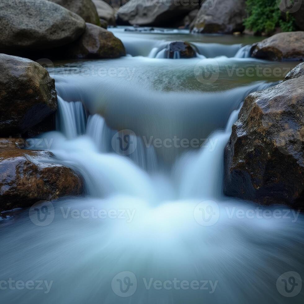 A stream flowing over rocks in a river photo