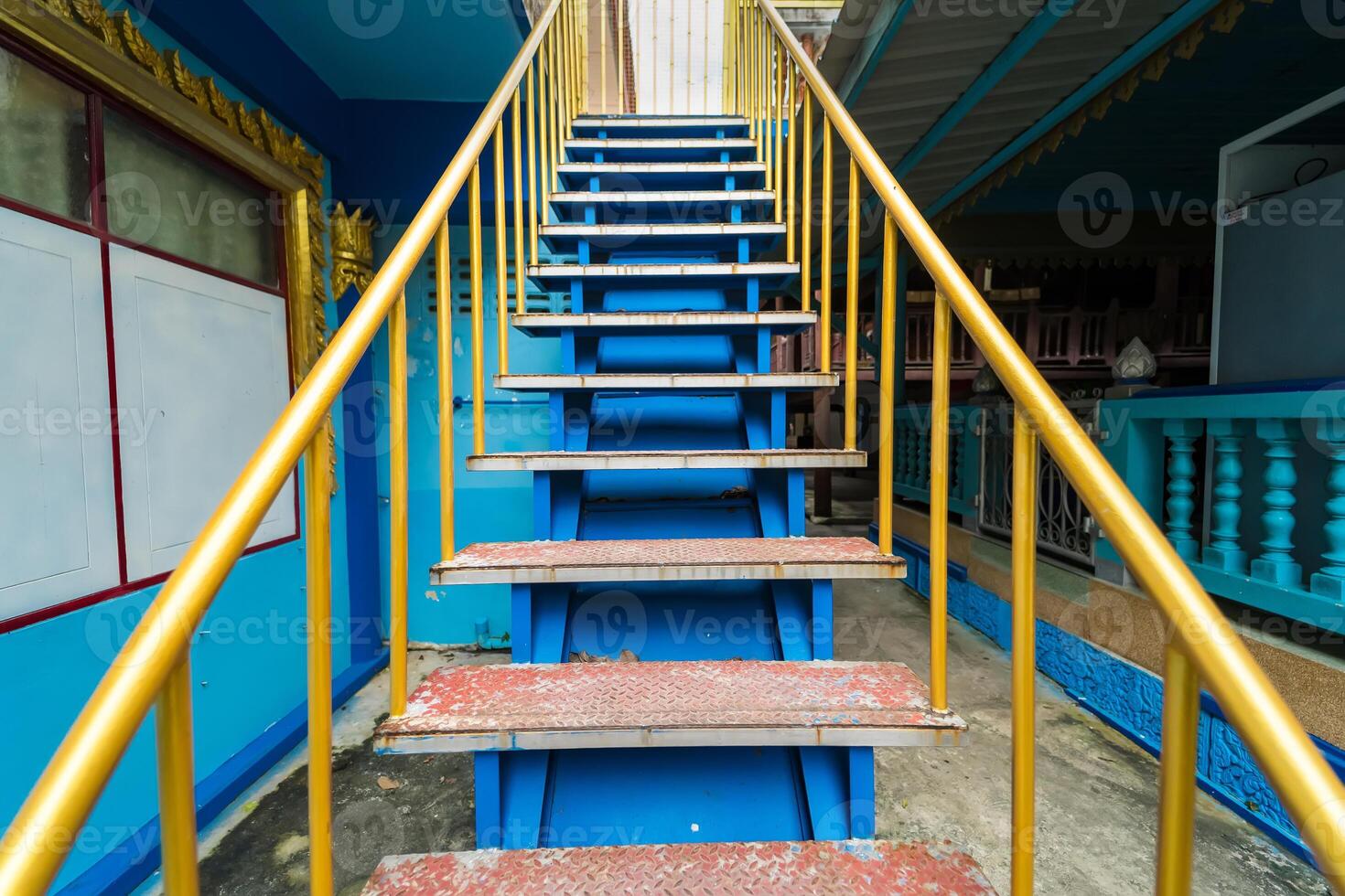 Colorful Staircase with Yellow Railings and Blue Steps in Public Space photo