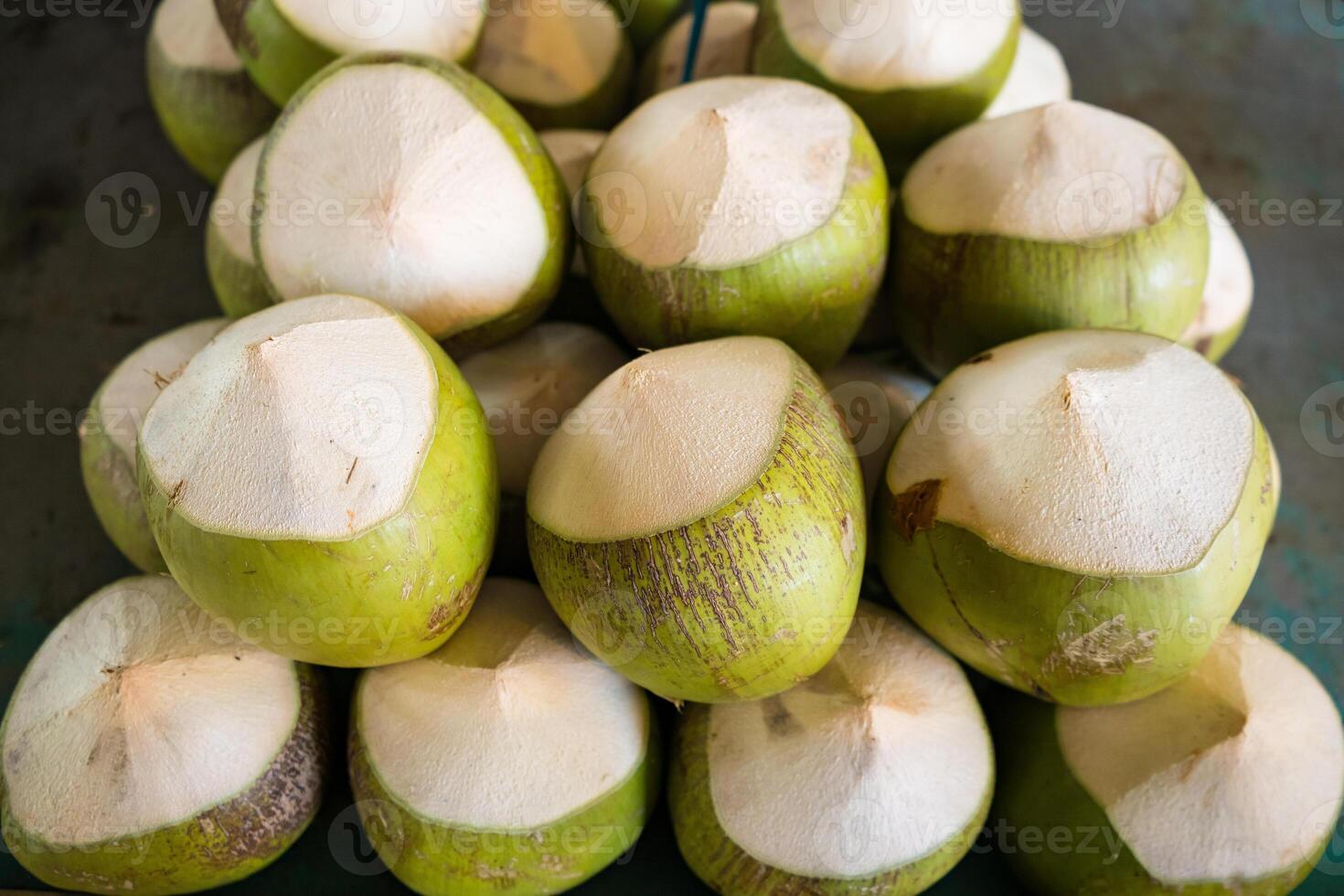 Fresh Green Coconuts with Tops Cut Off - Ready for Drinking and Enjoying Natural Coconut Water photo