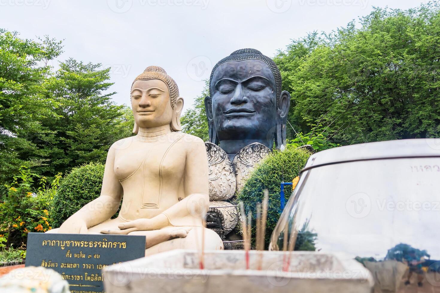Sacred Thai Buddha Statues with Incense Offerings in a Serene, Green Garden Setting at Ayutthaya, Thailand. photo