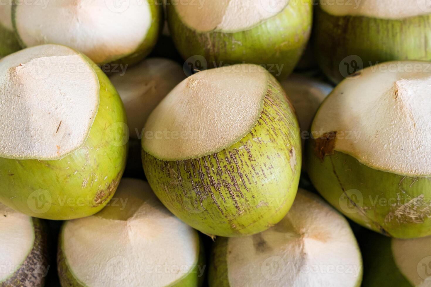 Fresh Green Coconuts with Tops Cut Off - Ready for Drinking and Enjoying Natural Coconut Water photo