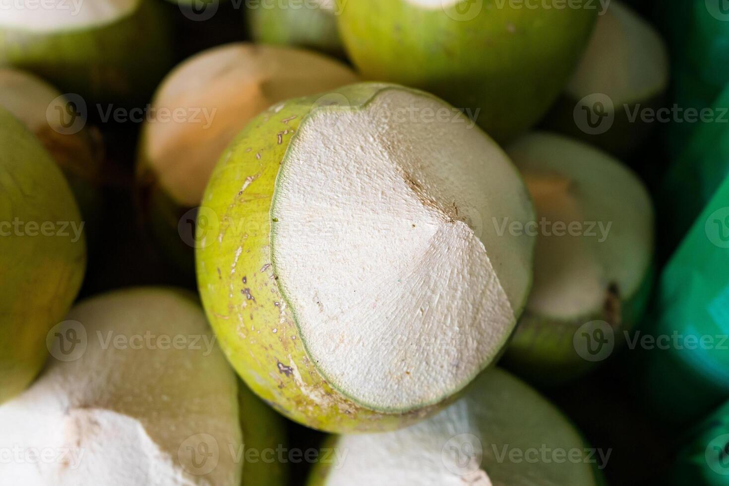 Fresh Green Coconuts with Tops Cut Off - Ready for Drinking and Enjoying Natural Coconut Water photo