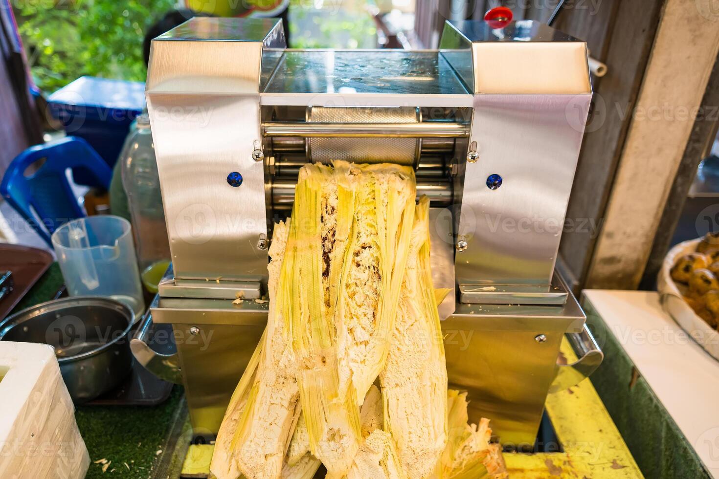 Commercial Sugarcane Press Machine in Action Crushing Cane Stalks for Sweet Juice photo