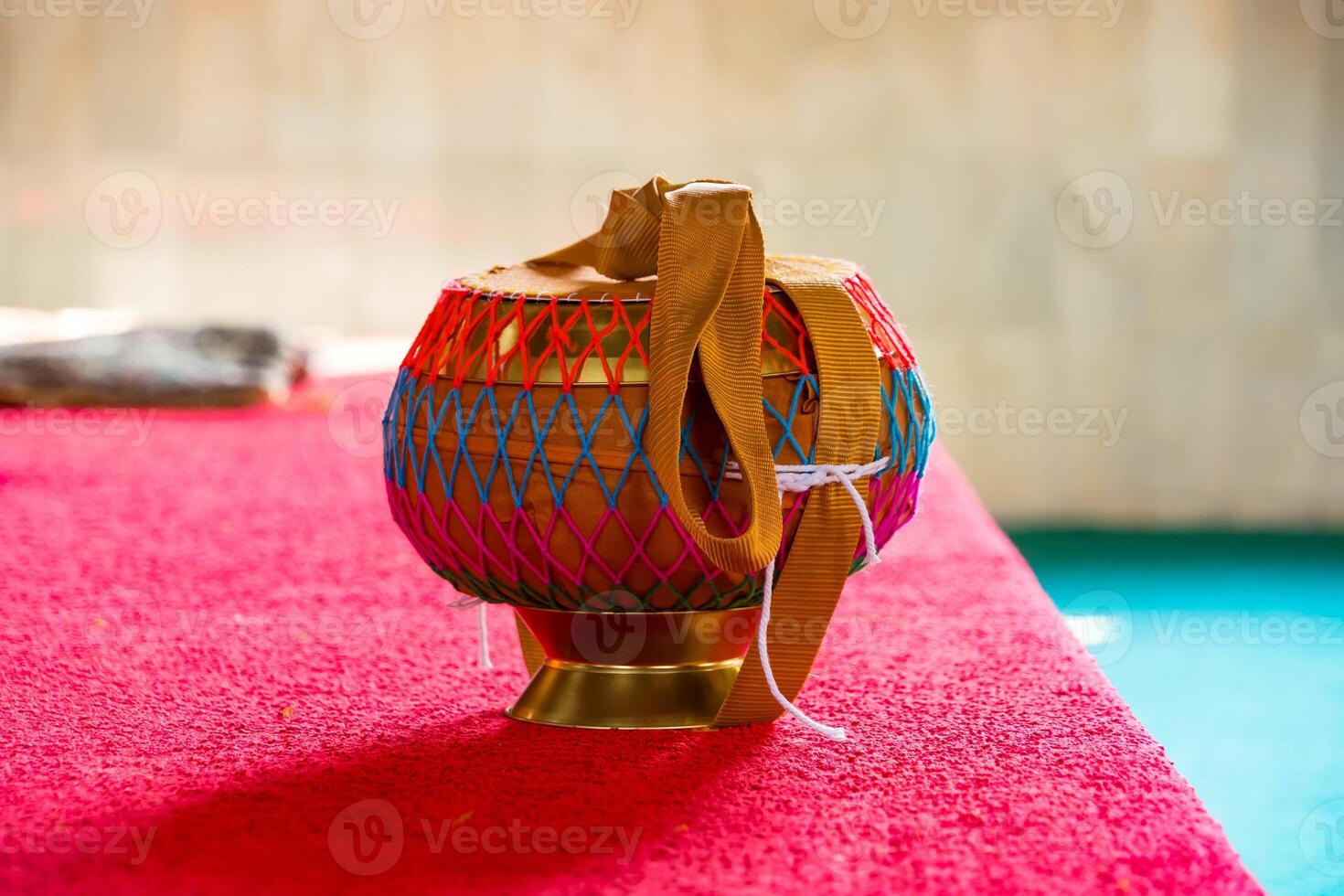 Monk's Alms Bowl Resting on the Floor of a Tranquil Buddhist Temple, Symbolizing Simplicity and Spirituality in a Sacred Space photo