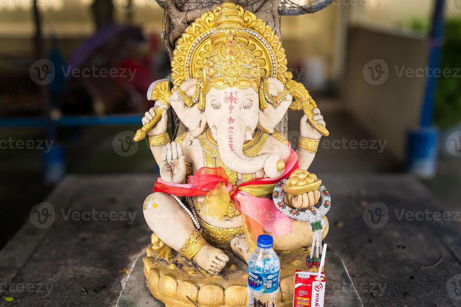 Ayutthaya, Thailand - April, 26, 2024 Serene Ganesha Idol with Traditional Offerings at Ayutthaya, Thailand. photo
