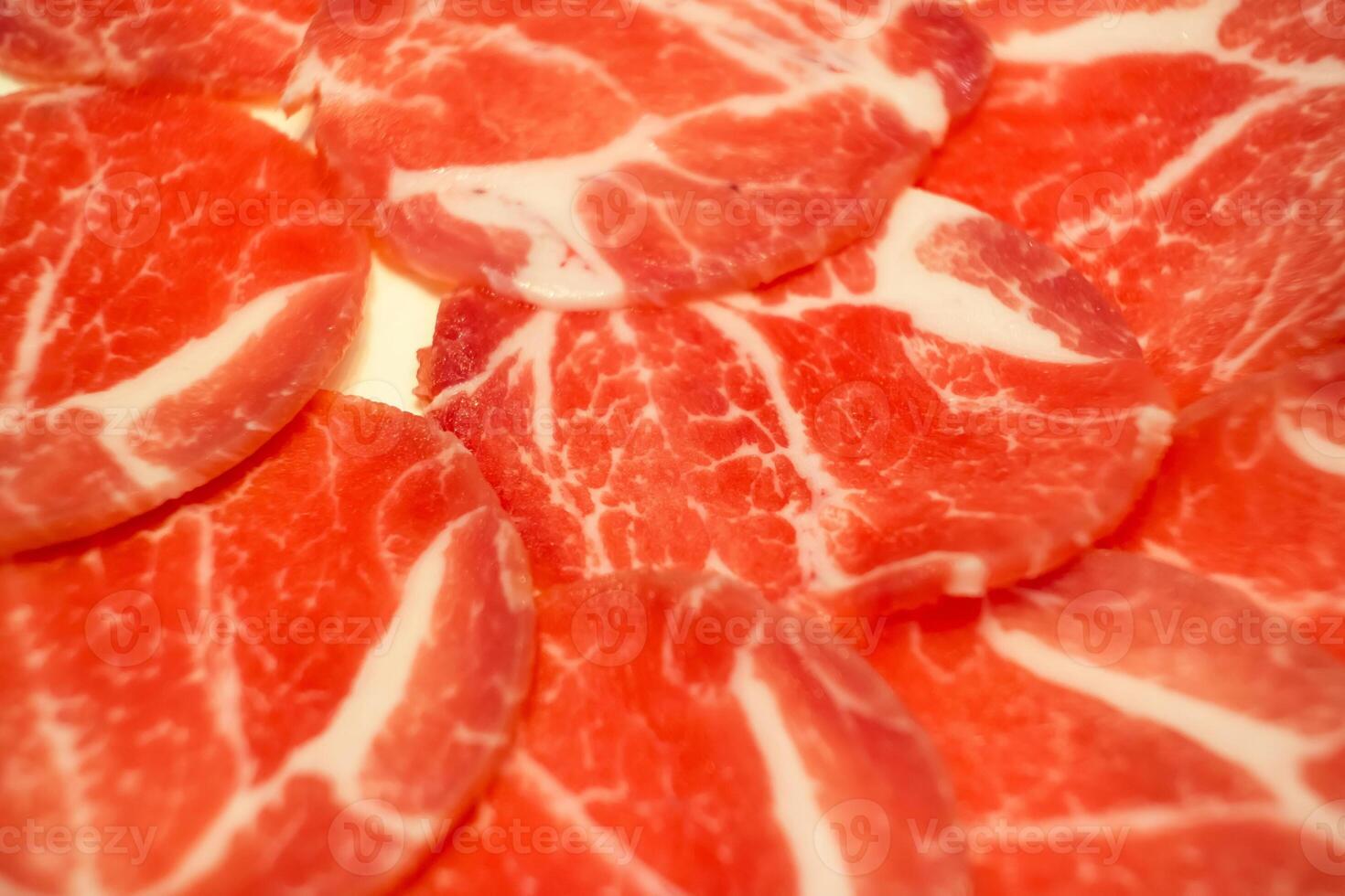 Close-up of raw marbled beef with sauce, perfect for culinary enthusiasts. photo