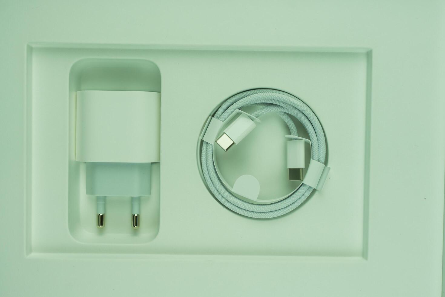 Bangkok, Thailand - October 30, 2024 A set of white smartphone charger. Charger and USB cable type C photo