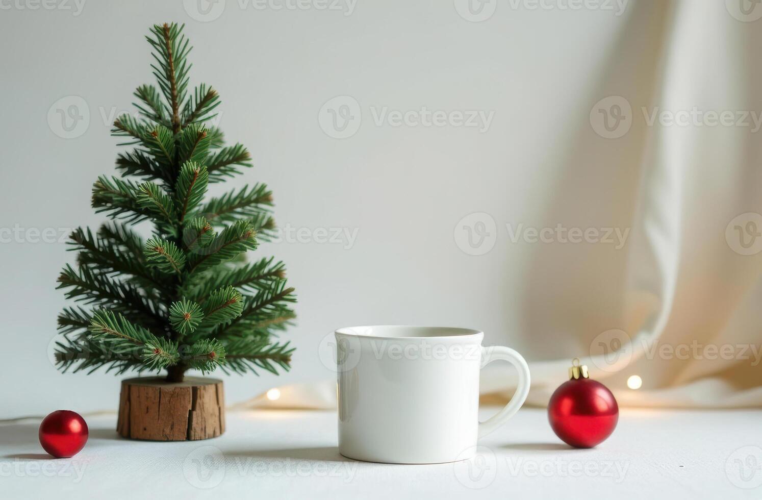 Festive christmas setup featuring a small artificial pine tree, a white blank mug, and red baubles. photo