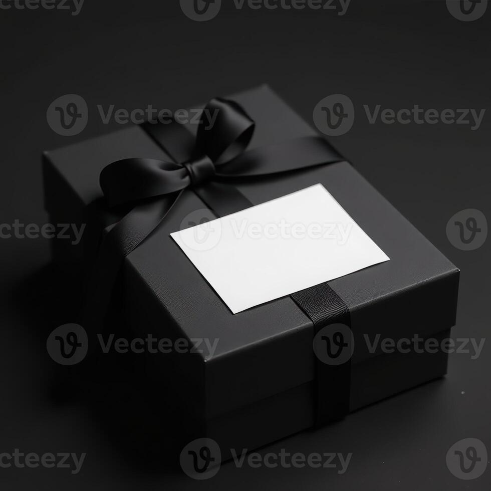 Elegant black gift box with blank card on dark background. black friday photo