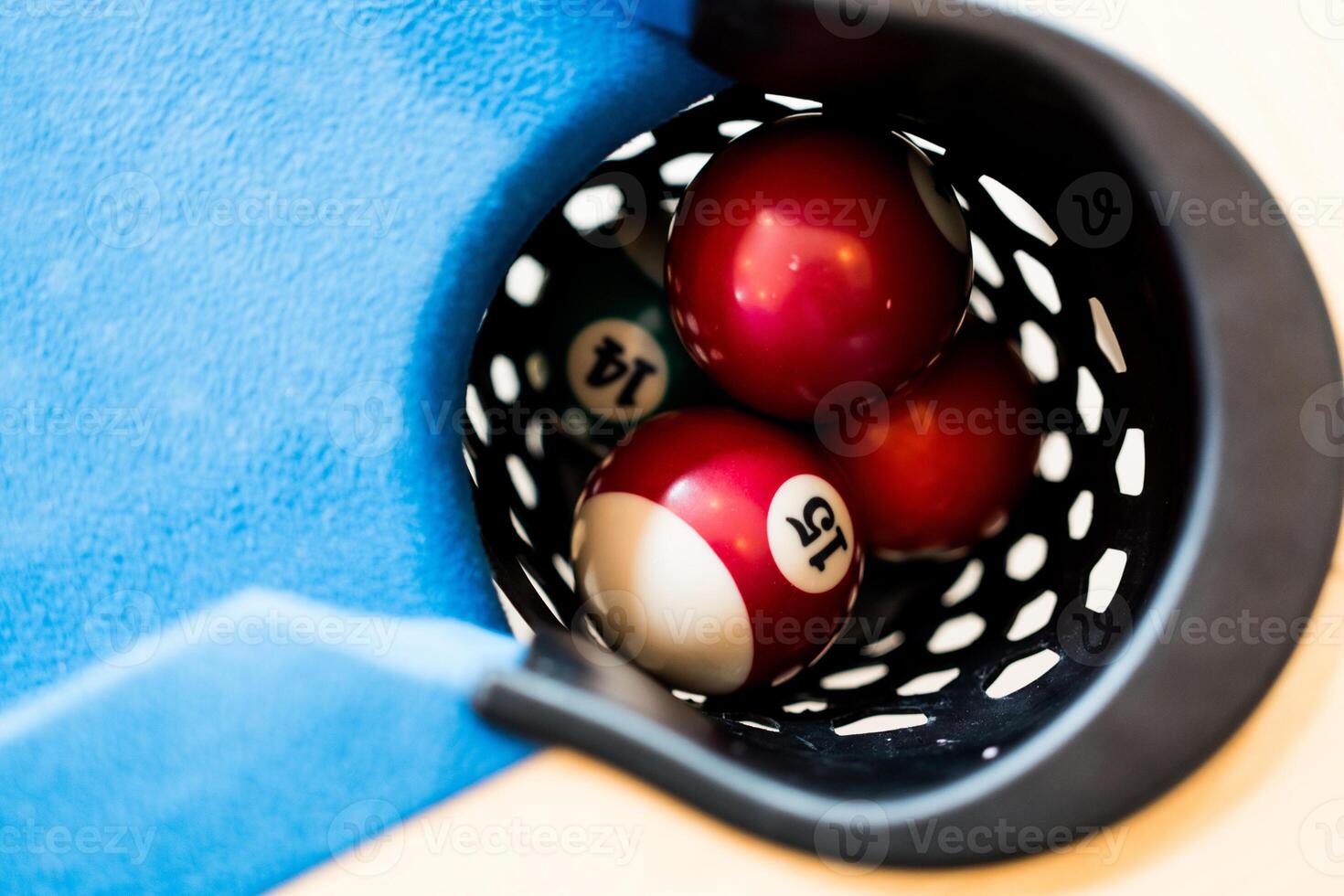 Close up of pool balls in hole photo