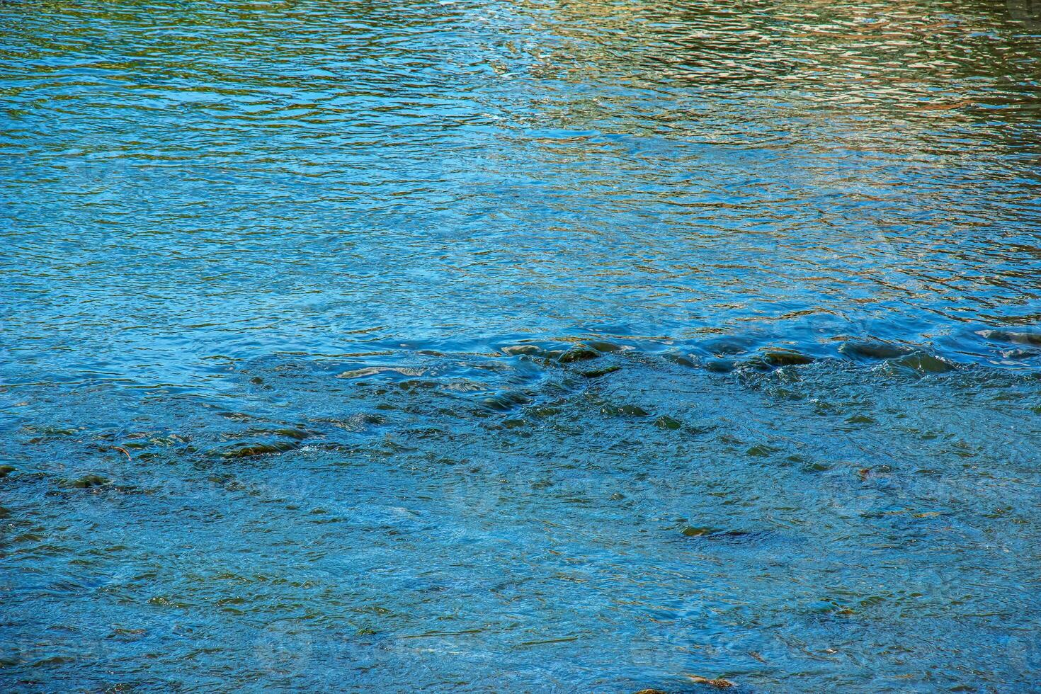 Closeup of the reflect and wave streak on the river background photo