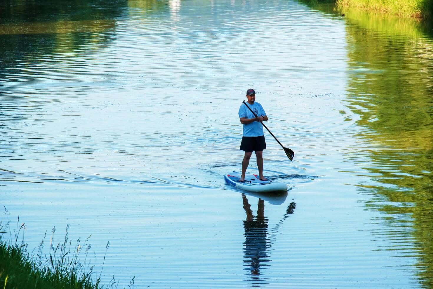 Nitra, Slovakia - 06.15.2022 A young man is sailing in a canoe on the Nitra river. photo