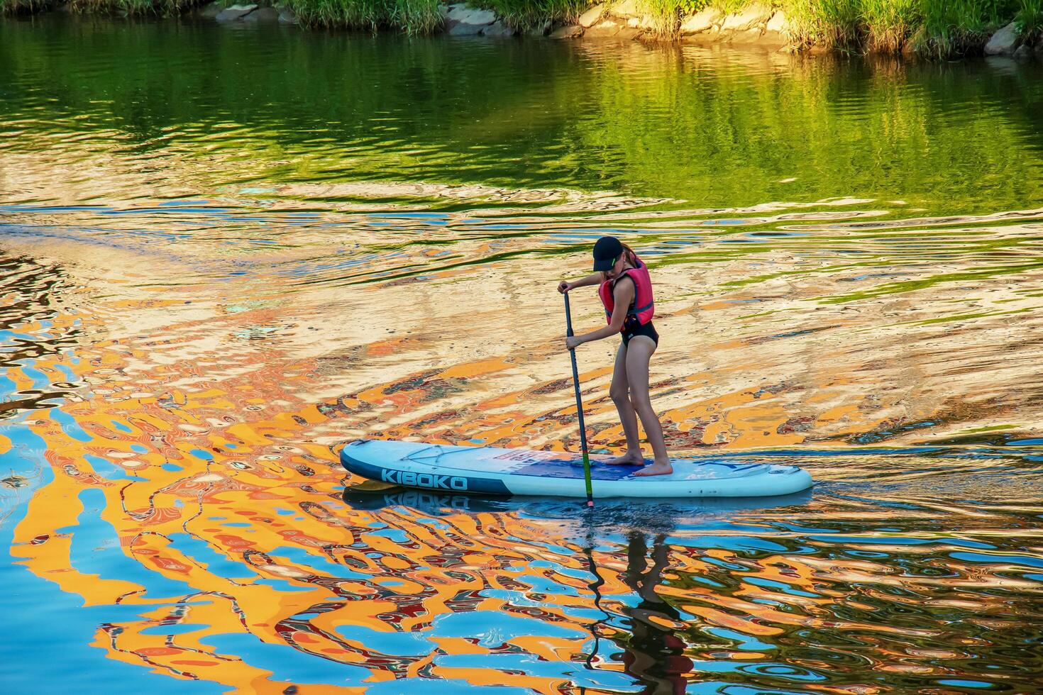Nitra, Slovakia - 06.15.2022 A young girl is sailing in a canoe on the Nitra river. photo
