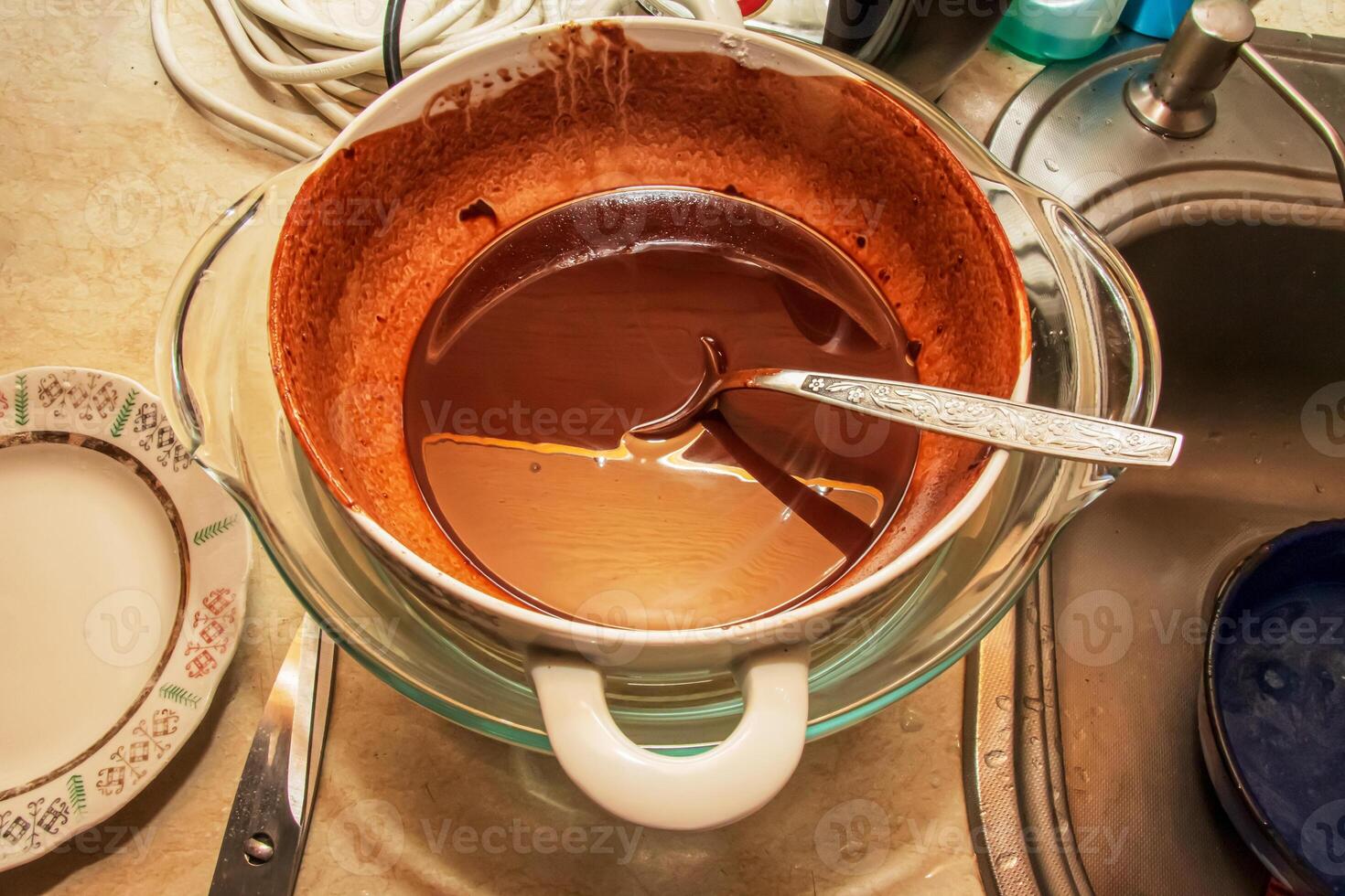 Homemade hot chocolate is ready to be poured into silicone molds. photo