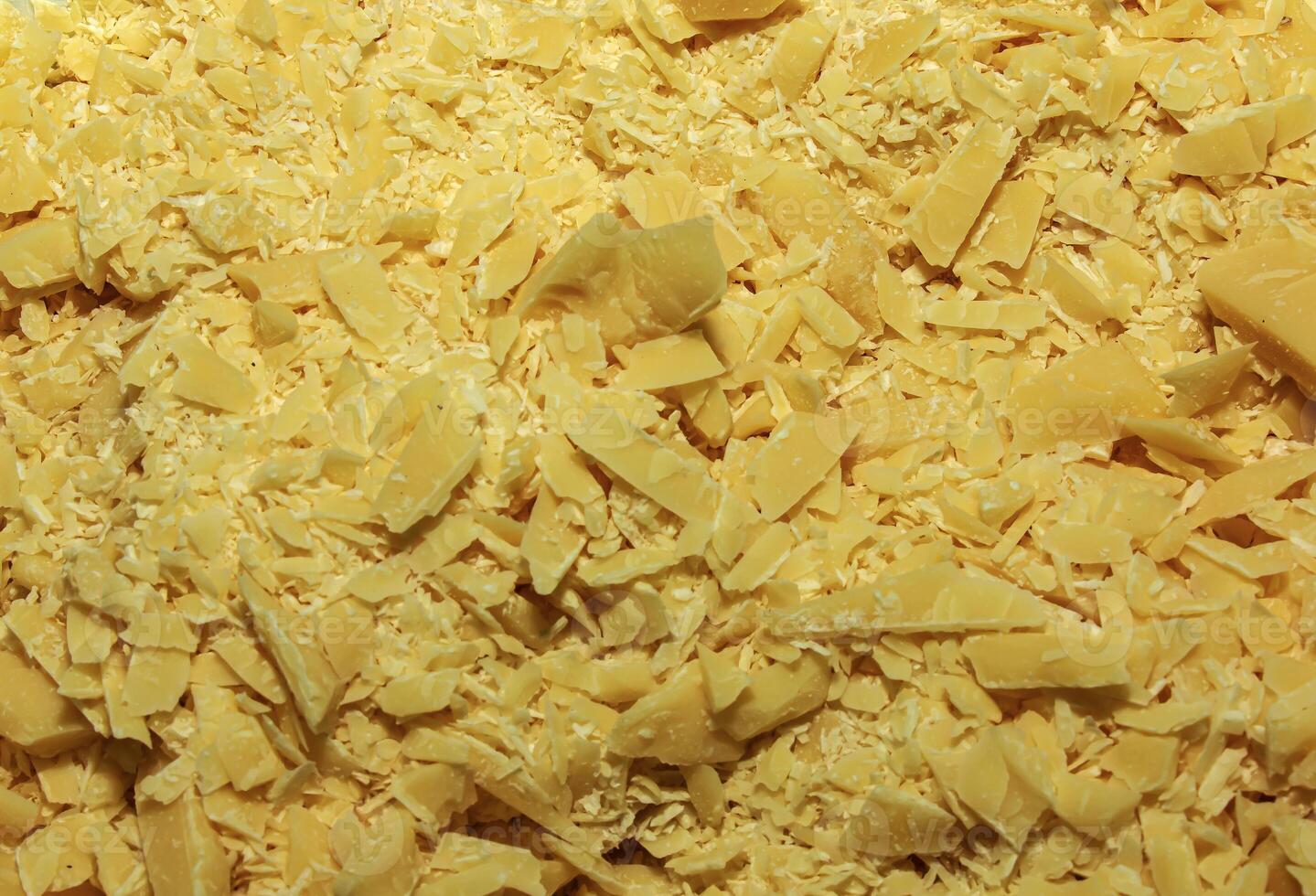 Cocoa butter background, top view, texture. Cocoa butter is one of the ingredients in making chocolate at home. Close-up of crushed cocoa butter, top view. photo