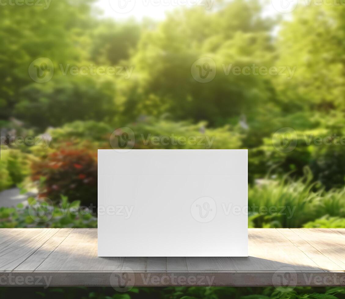 White greeting card mockup. Blank white rectangle sign mock up with blurred green garden background. Frame for product display or presentation. photo