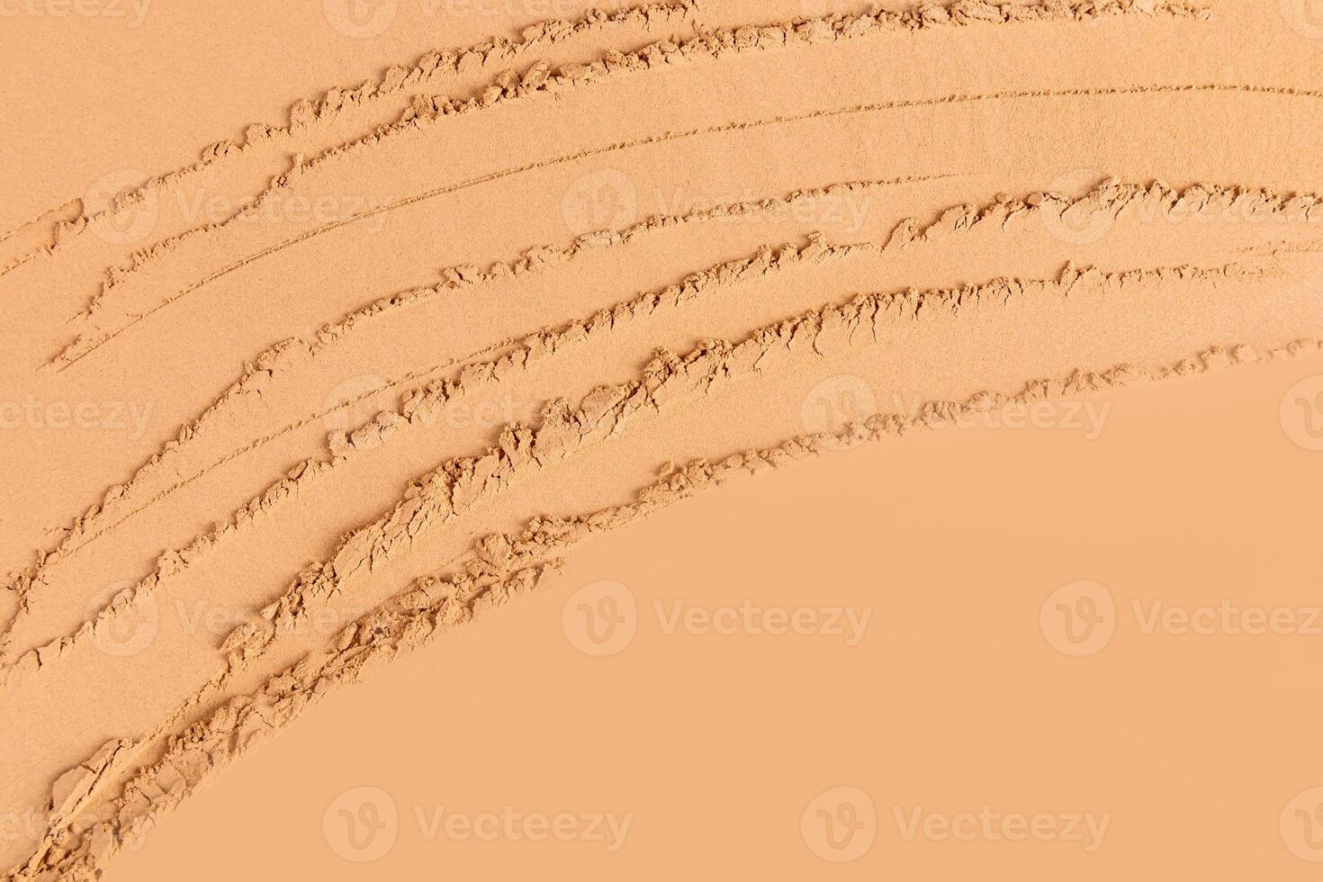 Abstract cosmetic texture background of loose powder in bronze, brown tone. layout for design. A copy space. top view. delicate texture. photo