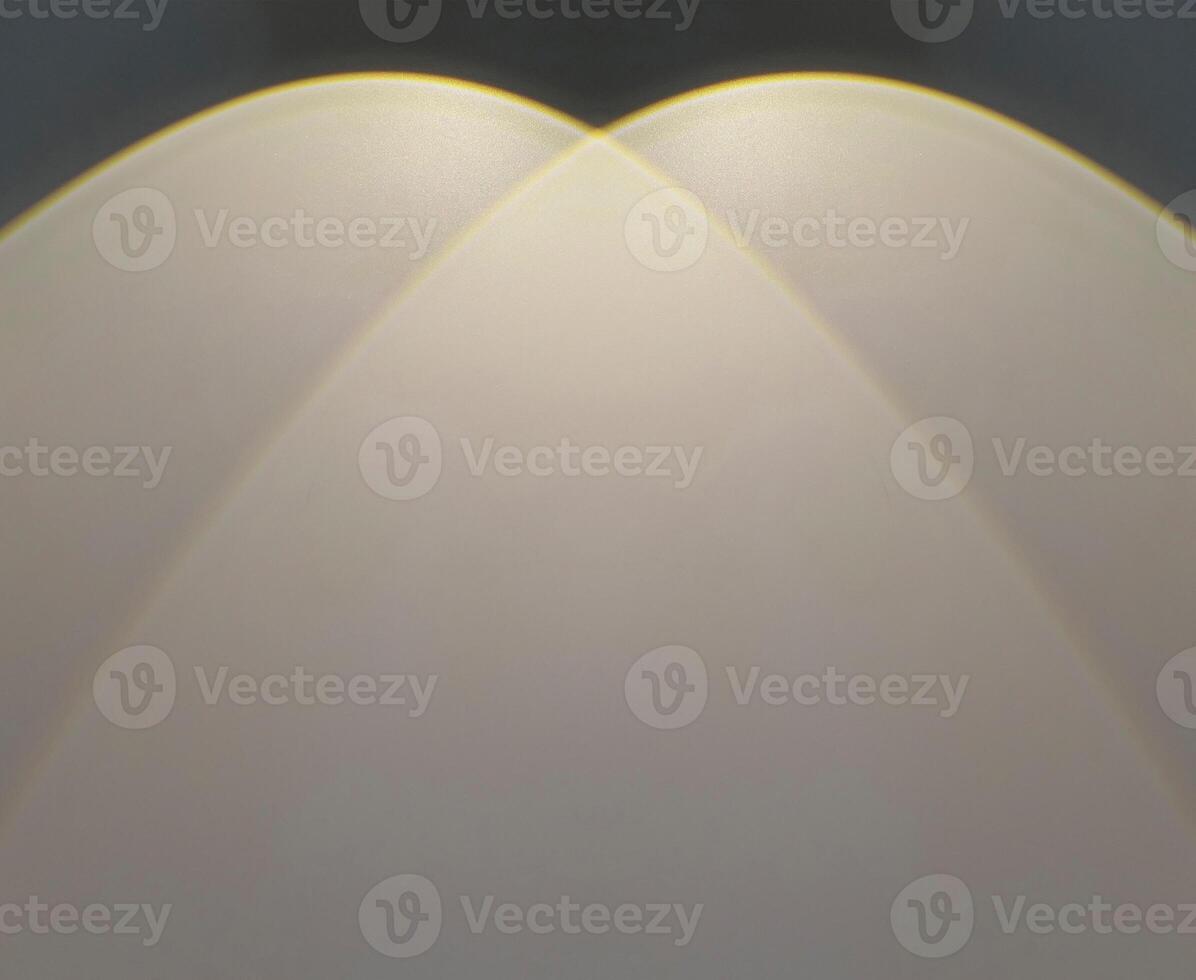 Warm light beam shines on a black wall. photo
