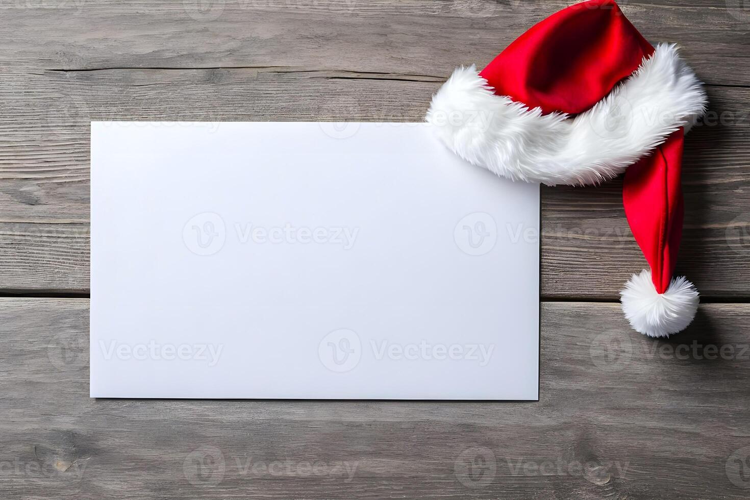 A blank white greeting card mockup along with red santa cap is placed on wooden background representing Christmas photo