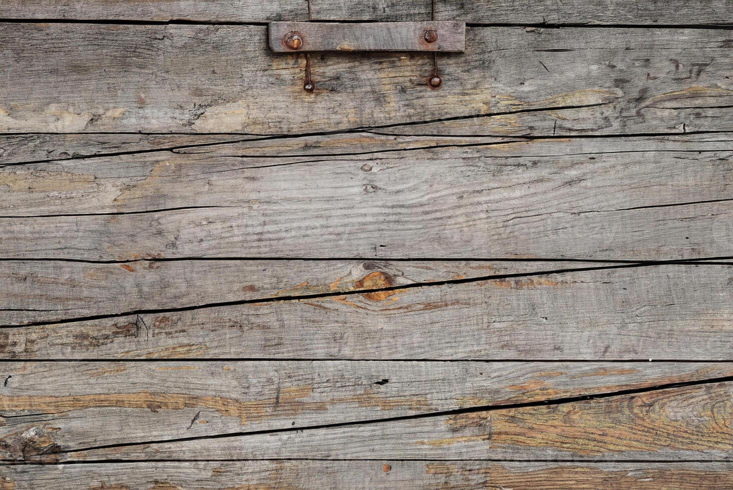 Close-up of aged, weathered wooden planks with visible grain and natural texture. photo