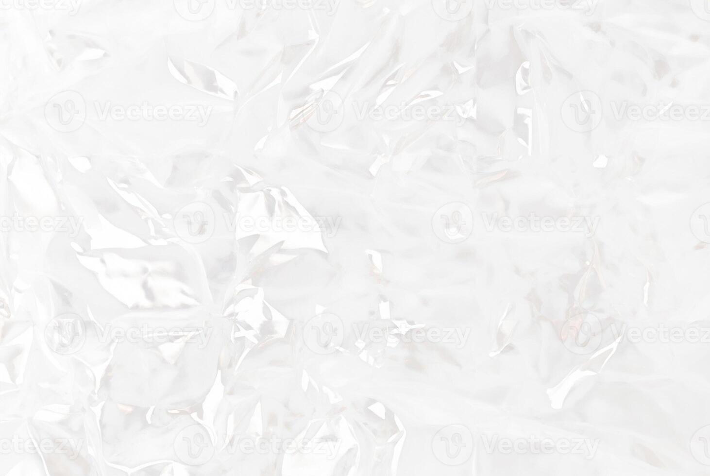 High-resolution close-up of crumpled transparent plastic sheet texture, ideal for use in packaging, backgrounds, or abstract design concepts. photo