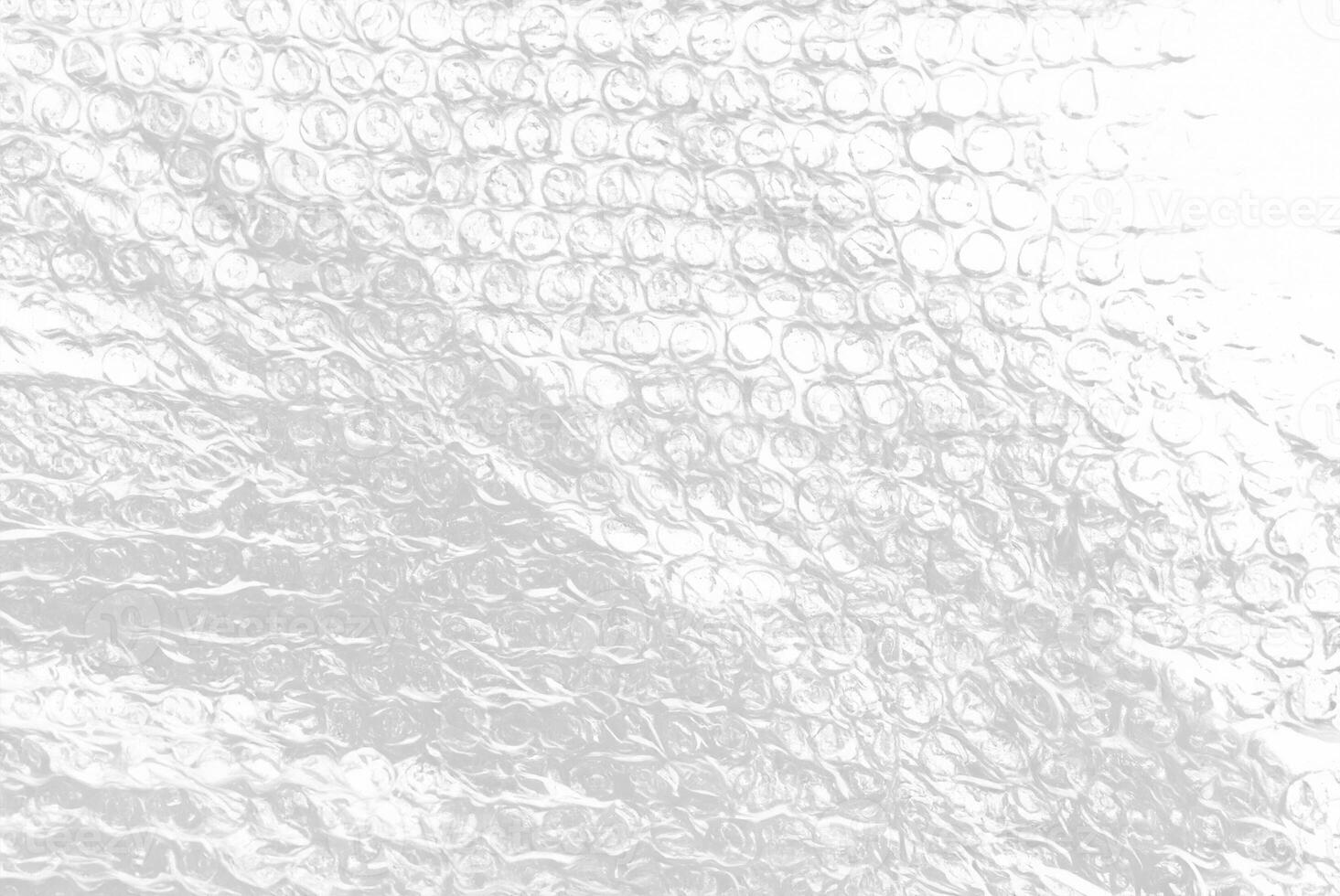 High-resolution close-up of bubble wrap texture, showing transparent air-filled pockets on a white background, ideal for packaging, background, or abstract design use. photo