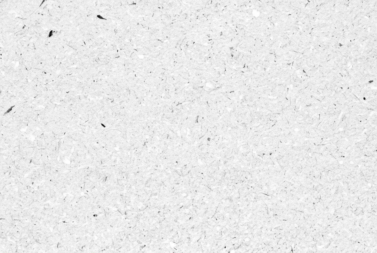 Textured white paper background with natural fibers and small speckles, ideal for design, crafts, or as a texture element. photo