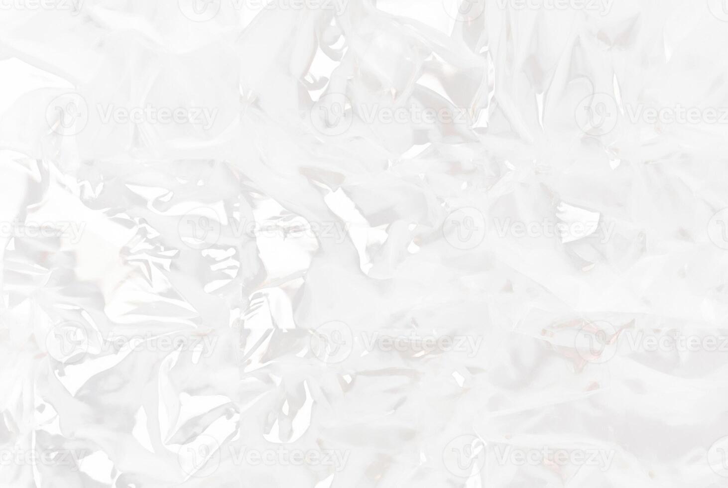 High-resolution close-up of crumpled transparent plastic sheet texture, ideal for use in packaging, backgrounds, or abstract design concepts. photo