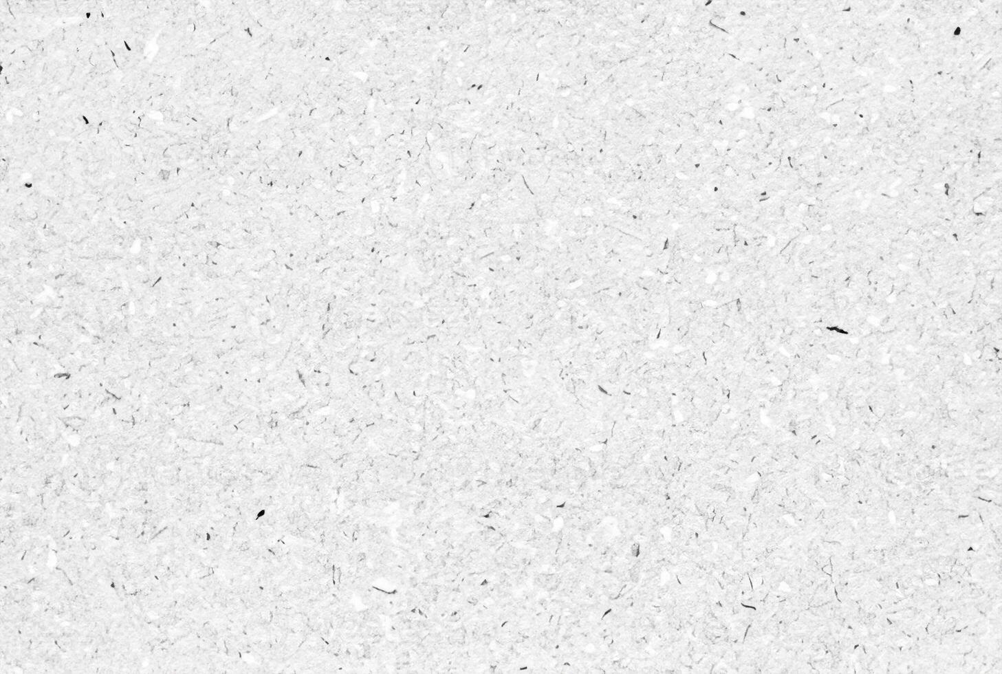 Textured white paper background with natural fibers and small speckles, ideal for design, crafts, or as a texture element. photo