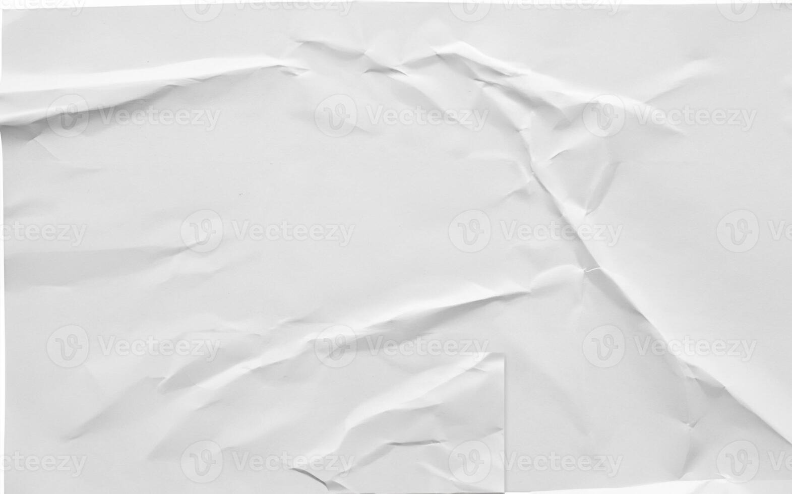 Crumpled white sheet of paper with folds and creases, isolated on a white background, ideal for design or texture use. photo